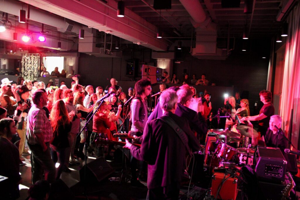 Crowd on its feet, seen from the stage