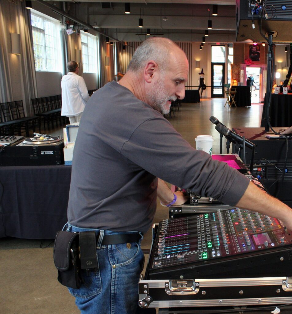 Engineer setting up a digital console before doors open