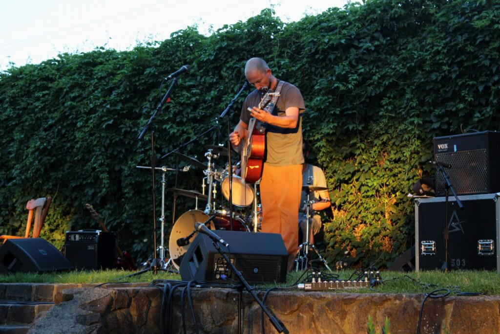 Live music on an outdoor garden stage at golden hour