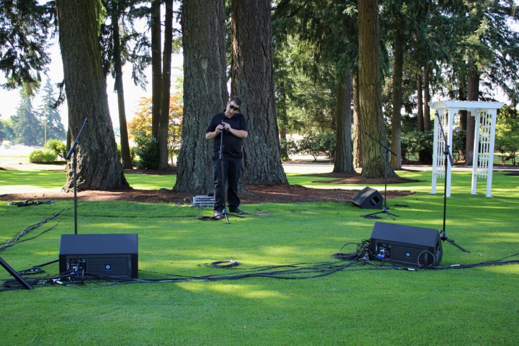 Outdoor ceremony sound on a tree-lined lawn