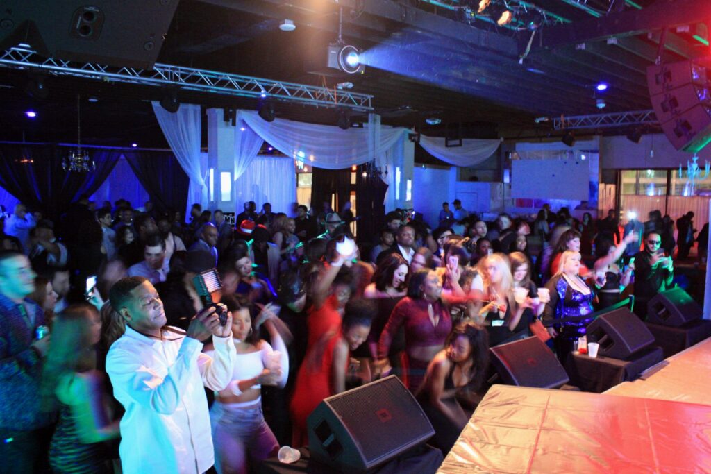 Packed dance floor in front of the stage at a night event