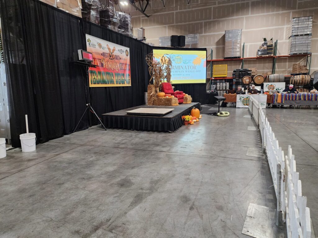 Indoor stage, scale and projection screen set for a giant pumpkin weigh-off