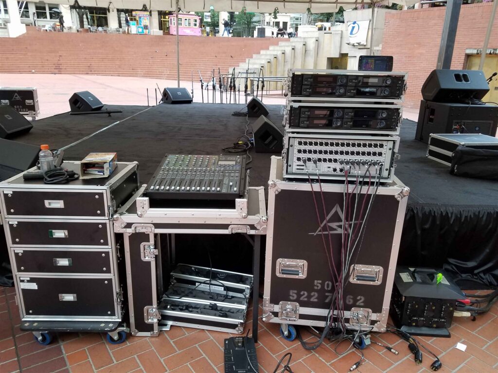 Road cases, mixer and amplifier racks staged for an outdoor event